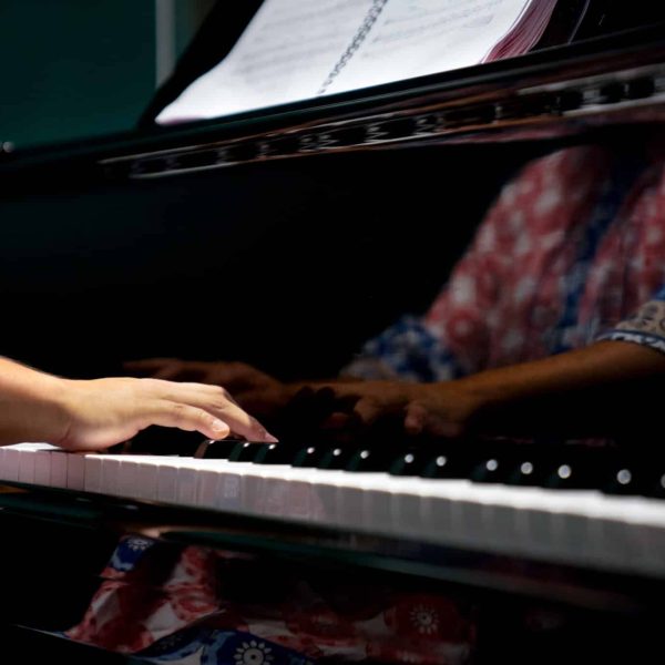 isolated-hands-playing-on-the-piano-dark-backgrou-2025-03-10-13-37-42-utc